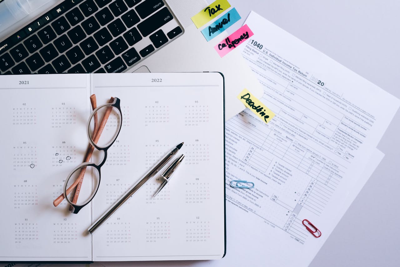 Teenused Organized workspace featuring a calendar, tax documents, and planner essentials.